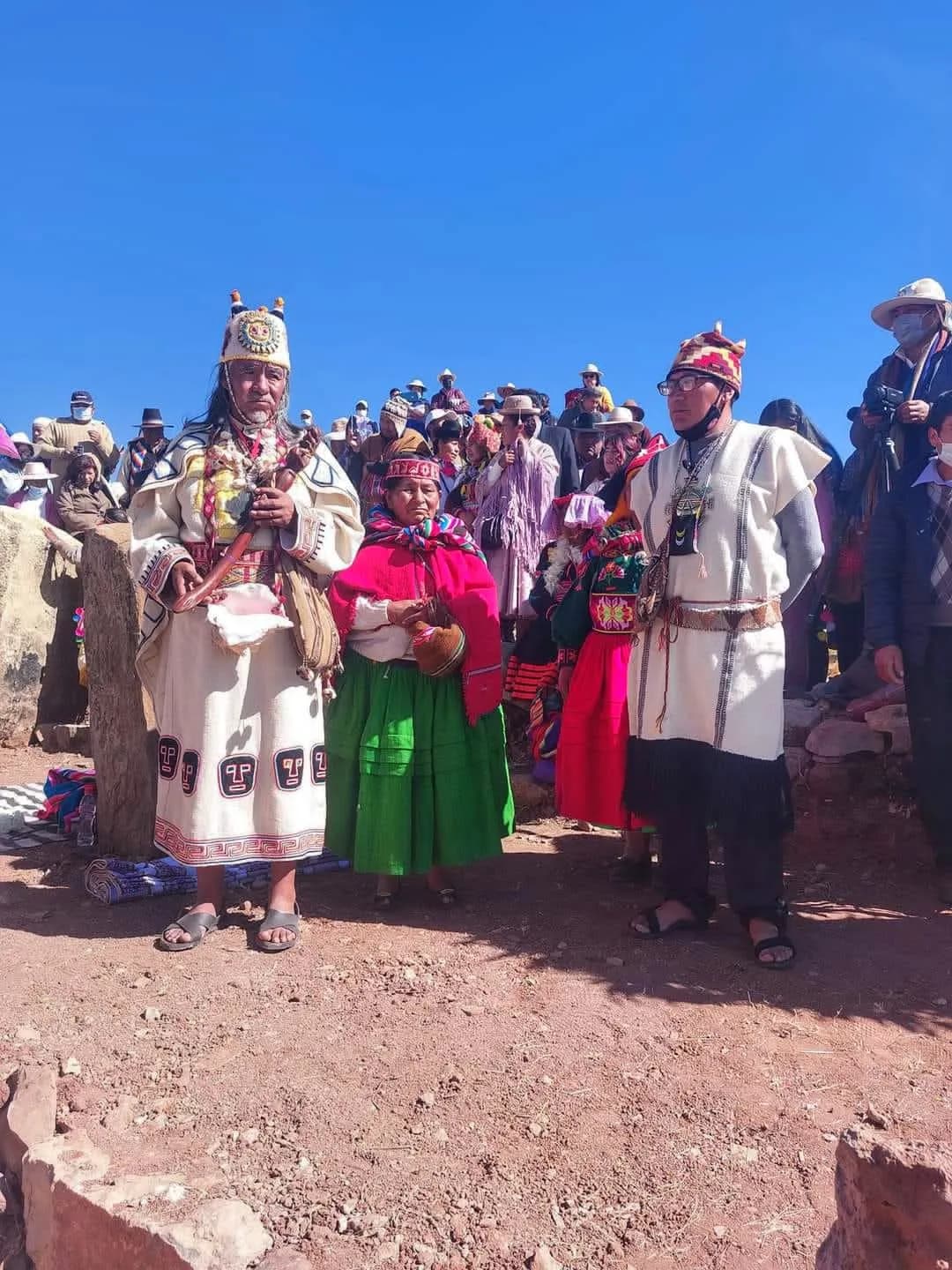 Andean authorities in traditional ceremonial dress during a celebration