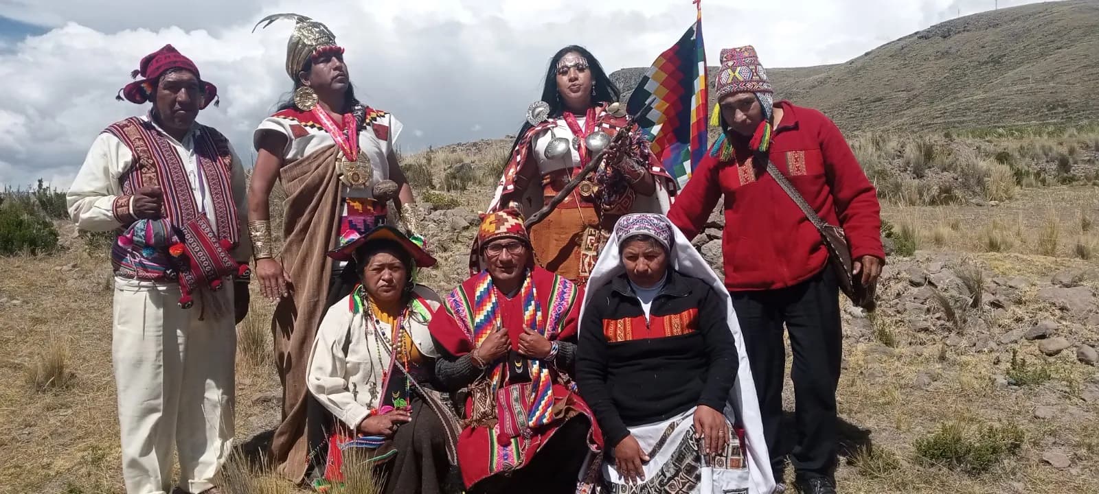 Andean ceremonial group with wiphala and staffs of authority on the altiplano
