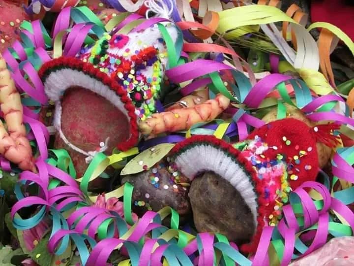 Carnival offering with colorful streamers and miniature chullos